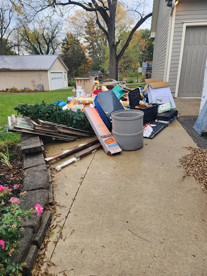 Dumpster being loaded with debris for Estate Cleanout Dumpster Rental in Chaska